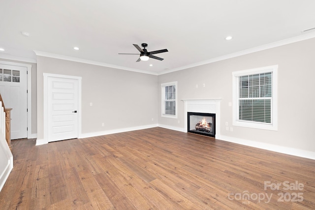 unfurnished living room featuring light hardwood / wood-style flooring, ceiling fan, and ornamental molding