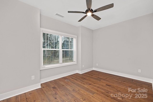 empty room with hardwood / wood-style floors and ceiling fan