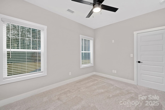 carpeted empty room featuring ceiling fan