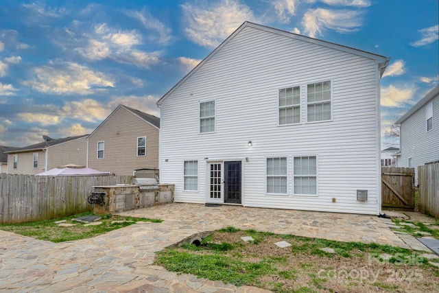 back of house featuring area for grilling and a patio area