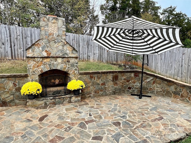 view of patio / terrace featuring an outdoor stone fireplace