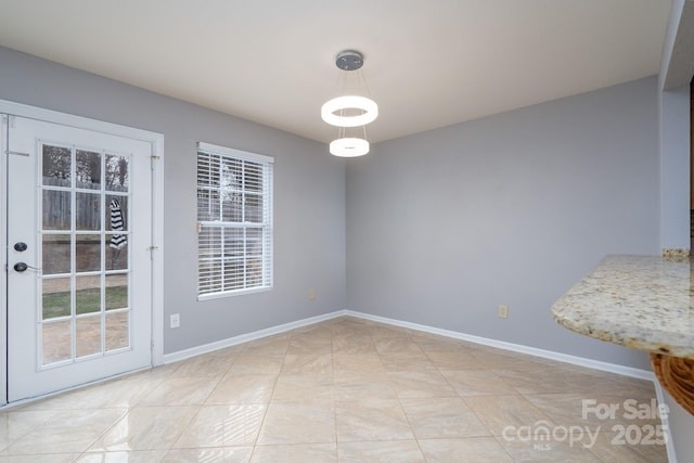 unfurnished dining area with light tile patterned flooring