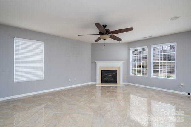 unfurnished living room with ceiling fan