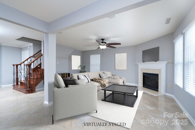 tiled living room with ceiling fan