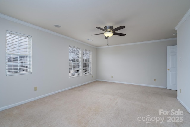 carpeted spare room with ceiling fan and crown molding