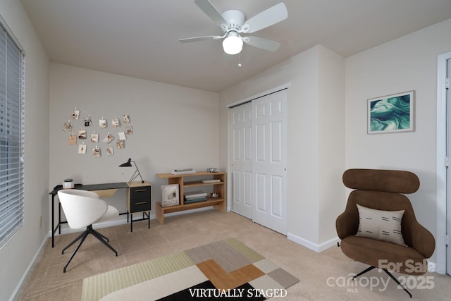 carpeted office space featuring ceiling fan