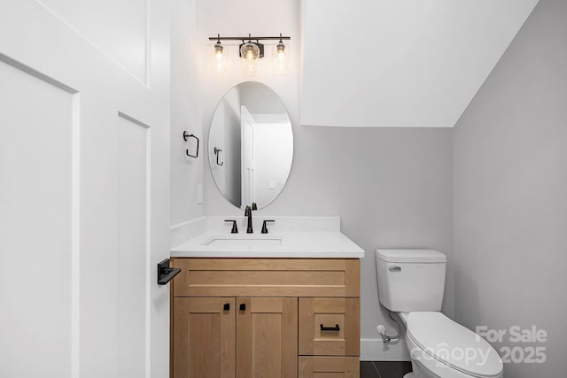 bathroom featuring tile patterned floors, vanity, and toilet