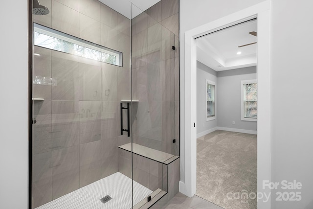 bathroom with ceiling fan and an enclosed shower