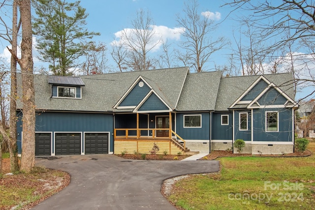 view of front of property featuring a garage and a front lawn