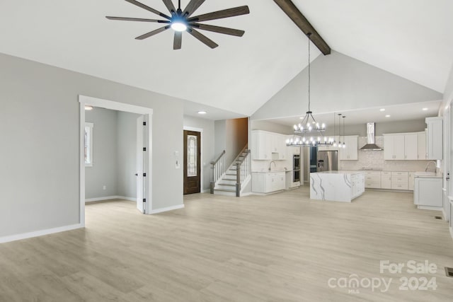 unfurnished living room featuring ceiling fan with notable chandelier, light hardwood / wood-style floors, sink, high vaulted ceiling, and beam ceiling