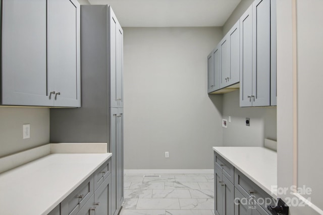 washroom with washer hookup, cabinets, and electric dryer hookup