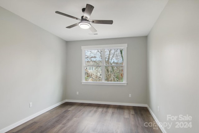 unfurnished room with ceiling fan and dark hardwood / wood-style flooring