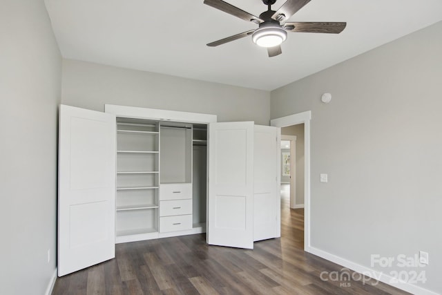 unfurnished bedroom featuring ceiling fan, dark hardwood / wood-style floors, and a closet