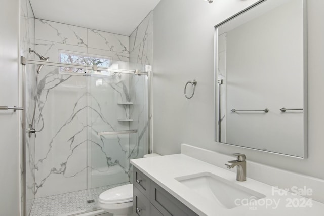 bathroom with vanity, toilet, and an enclosed shower