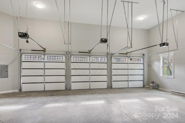 garage featuring a garage door opener and electric panel