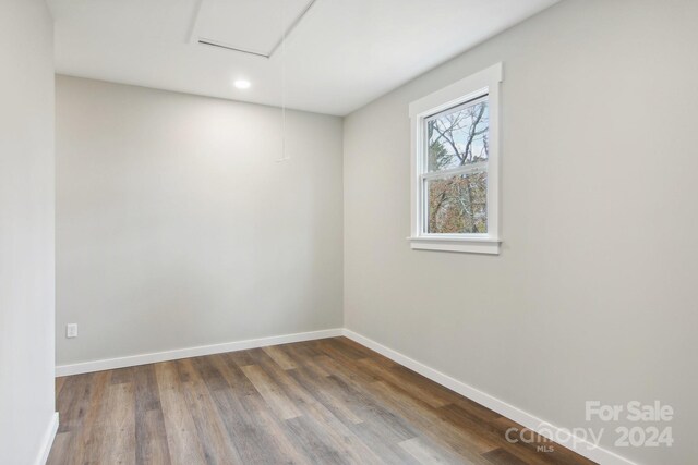 empty room with hardwood / wood-style flooring