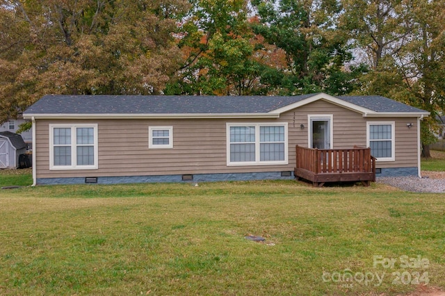 view of front of property with a front yard and a deck