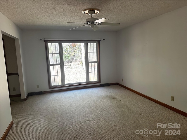 unfurnished room featuring carpet, a textured ceiling, and ceiling fan