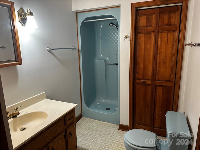 bathroom featuring a shower, vanity, and toilet