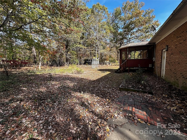 view of yard with a sunroom