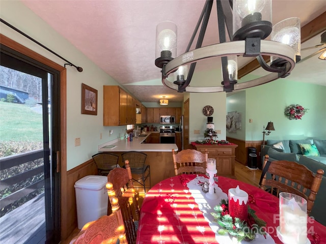 12 Boulder Ln, Maggie Valley, NC 28751 - dining area featuring wainscoting, plenty of natural light, and light wood-type flooring