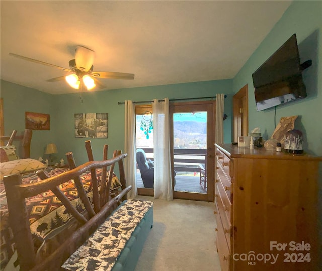 carpeted bedroom featuring access to outside and ceiling fan