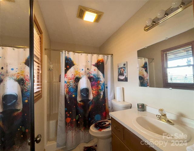 bathroom featuring walk in shower, vanity, and toilet