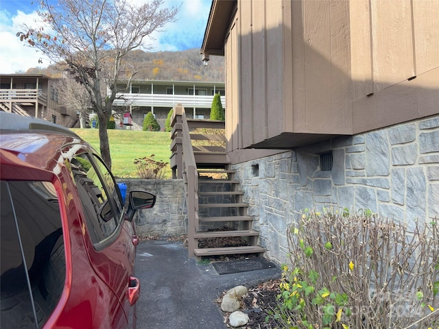 12 Boulder Ln, Maggie Valley, NC 28751 - view of side of property with stone siding, stairway, and a lawn