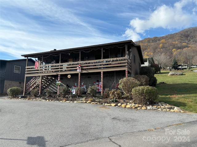 12 Boulder Ln, Maggie Valley, NC 28751 - view of front of home with a front lawn, a mountain view, and stairs