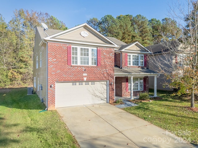 view of front of property with central AC, a front yard, and a garage