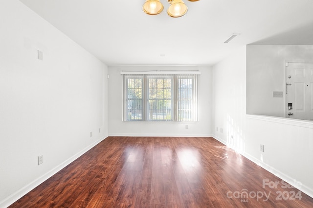 spare room featuring dark hardwood / wood-style flooring