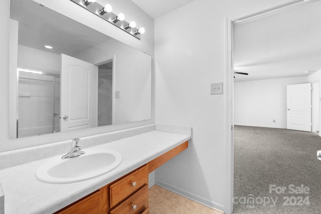 bathroom featuring vanity and an enclosed shower