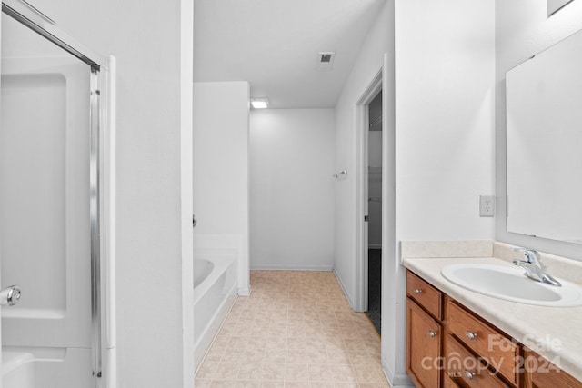 bathroom with a tub and vanity