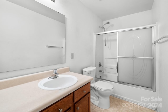 full bathroom featuring shower / bath combination with glass door, vanity, and toilet