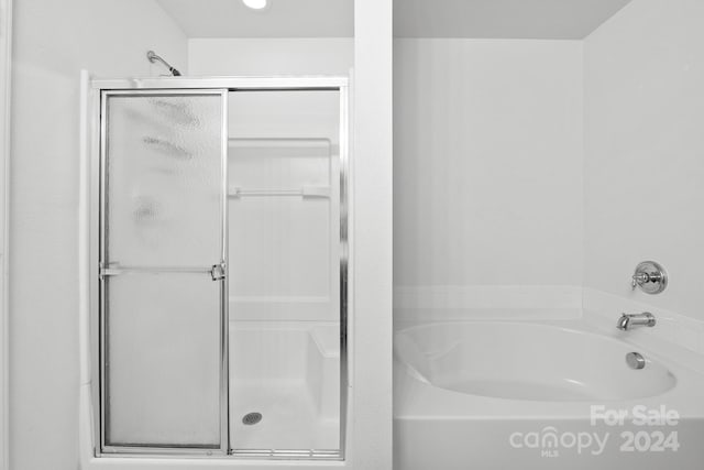 bathroom with shower with separate bathtub