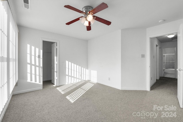 carpeted spare room with ceiling fan