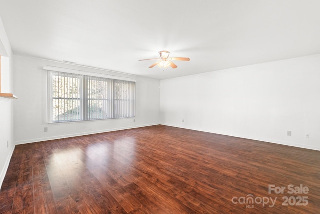 unfurnished living room with ceiling fan and dark hardwood / wood-style flooring