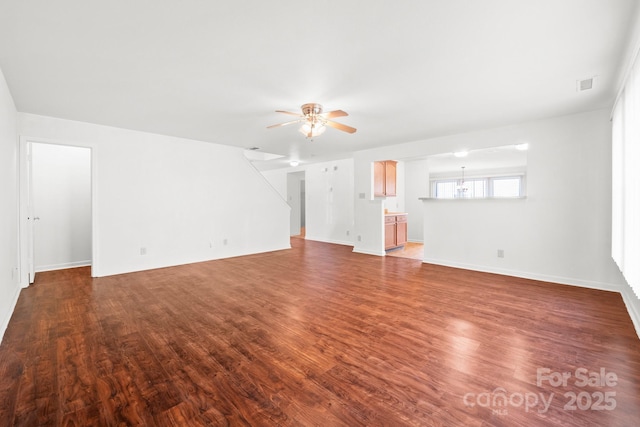 unfurnished living room featuring dark hardwood / wood-style flooring and ceiling fan