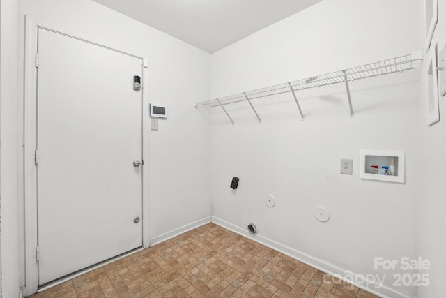 clothes washing area featuring gas dryer hookup and washer hookup