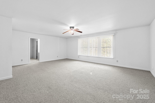 spare room featuring light carpet and ceiling fan