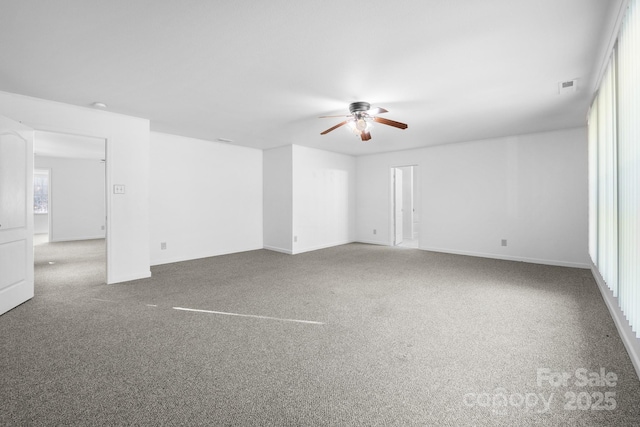 carpeted spare room featuring ceiling fan