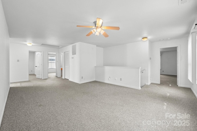 carpeted empty room featuring ceiling fan