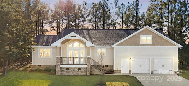 view of front facade with a yard and a garage