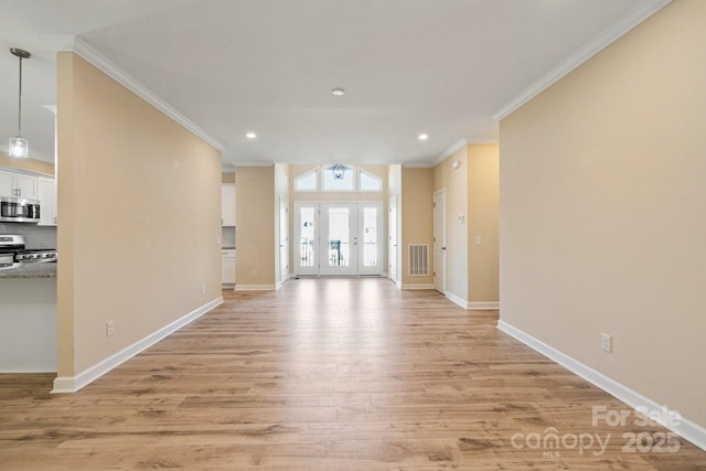 unfurnished living room featuring light wood-type flooring and ornamental molding