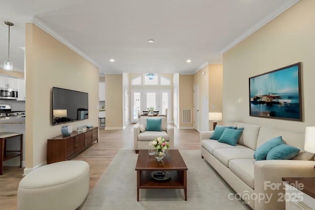 living room with light hardwood / wood-style flooring and ornamental molding