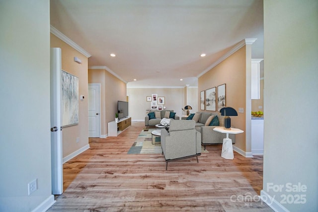 living room with ornamental molding and light hardwood / wood-style flooring