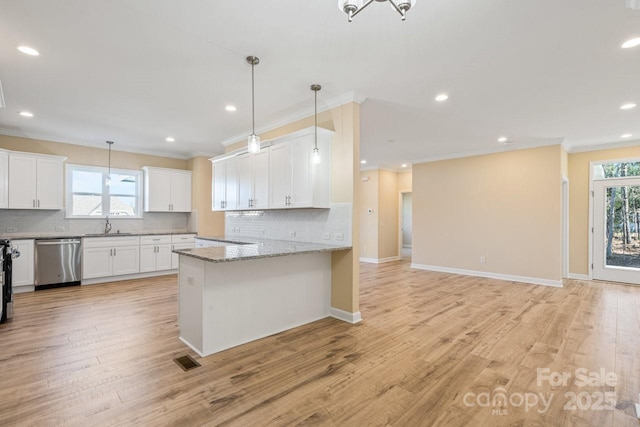 kitchen with kitchen peninsula, light stone countertops, white cabinets, ornamental molding, and dishwasher