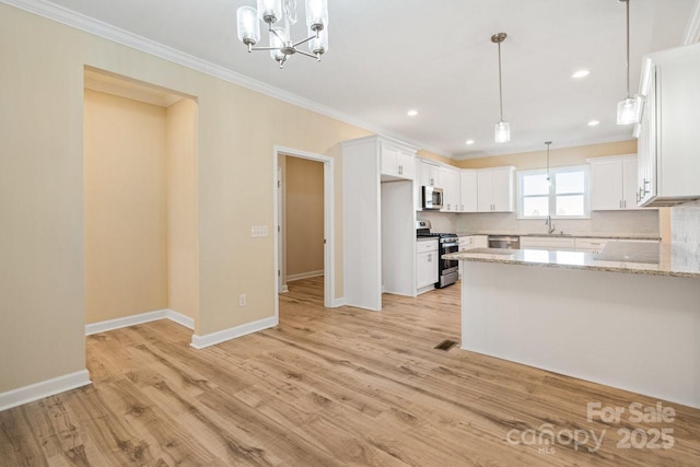 kitchen featuring light stone counters, white cabinetry, and stainless steel appliances