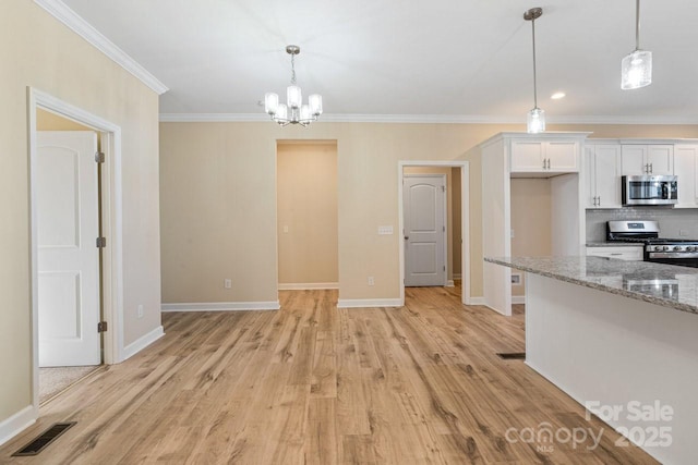 kitchen featuring stainless steel appliances, white cabinetry, hanging light fixtures, and light stone counters