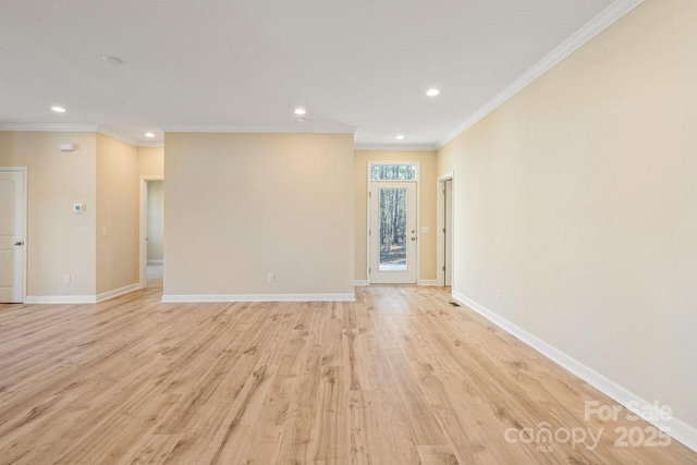 unfurnished living room featuring light wood-type flooring and ornamental molding